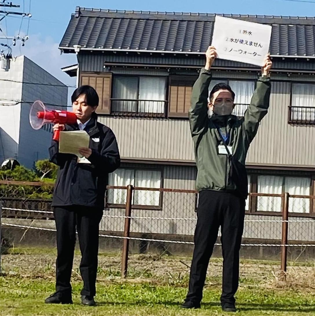 メガホンで話をする男性と、スケッチブックを掲げる男性