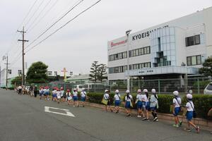 共栄社のビルの近くを児童が列になって歩いている写真