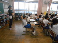 国語の授業を教室後方から観察している教育実習生の写真