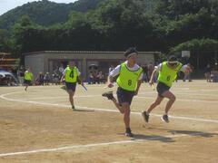 黄色いゼッケンを着た児童たちが走っている写真