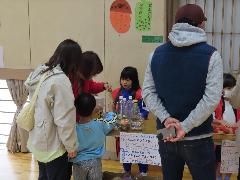 お家の方に遊び方を説明する子ども