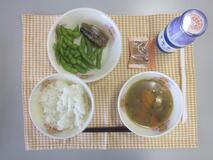 テーブルクロスに並べられたごはん・牛乳・けんちん汁・さんまのみぞれ煮・えだ豆・コーヒー糖の写真