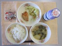 テーブルクロスに並べられたごはん・牛乳・白みそ汁・とり肉のあま酢あんかけ・キャベツ炒め・アーモンド小魚の写真